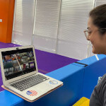A young lady attending virtual classes on a computer.