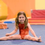 Young gymnast at the gym, stretching.
