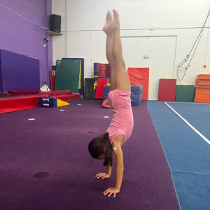 Handstand Contest winner, girl doing handstand.