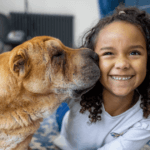 Girl smiling with her pet dog