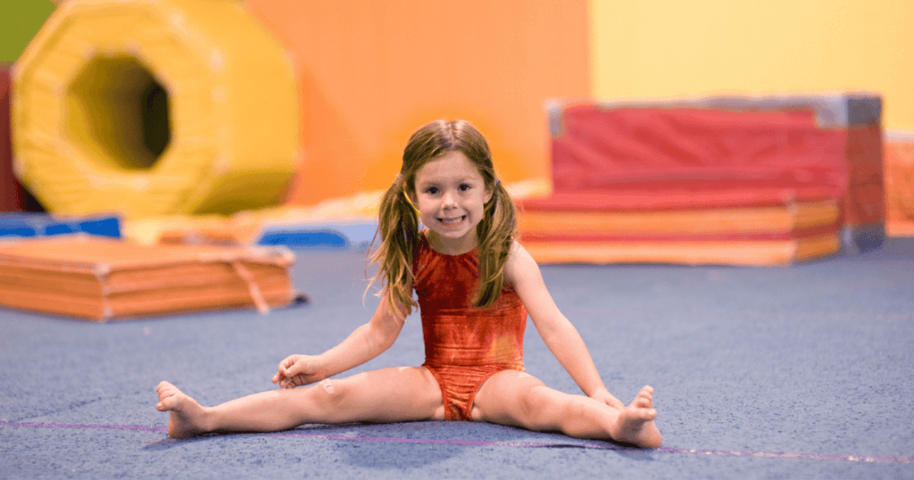 Young gymnast at the gym, stretching.