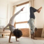 Father and Daughter doing gymnastics handstand together