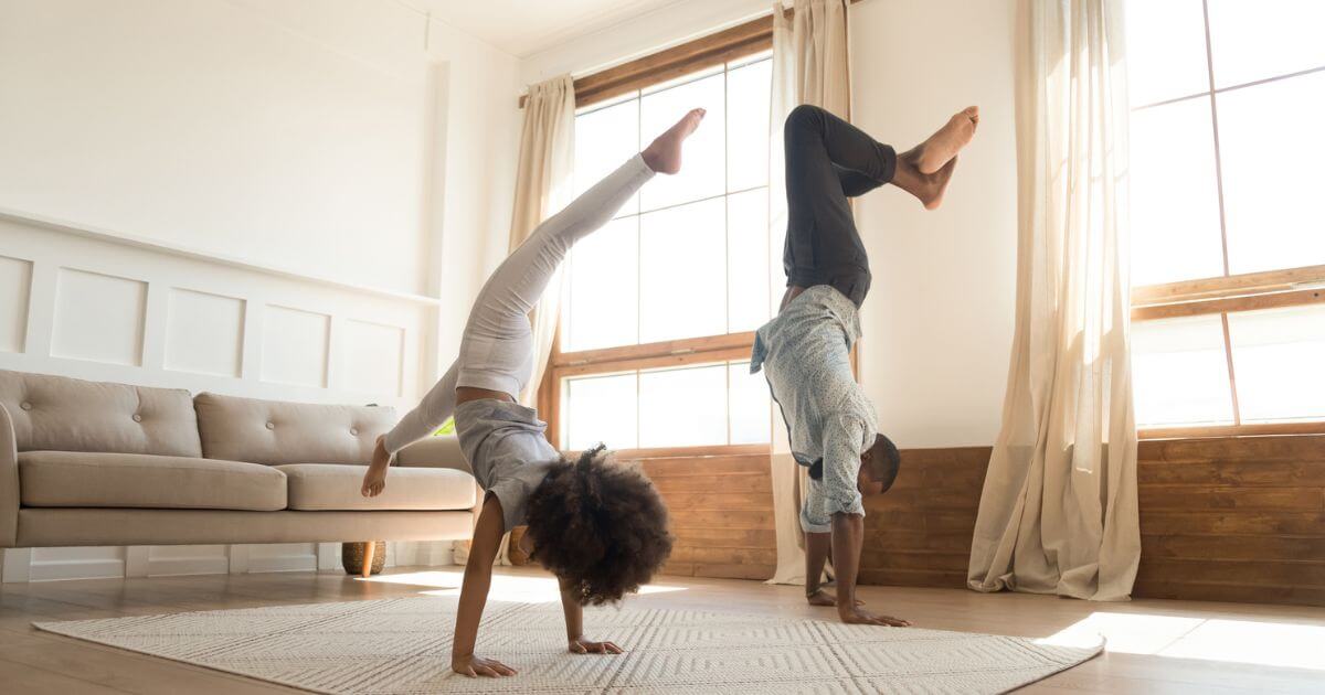 Father and Daughter doing gymnastics handstand together 
