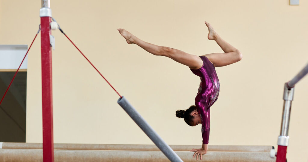 Gymnast practicing on the balance beam.