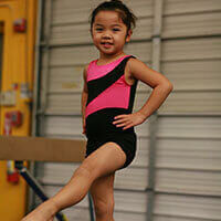 Young girl doing preschool aged gymnastics.